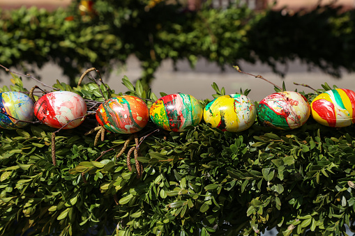 Decorative Easter eggs on a fountain in the city