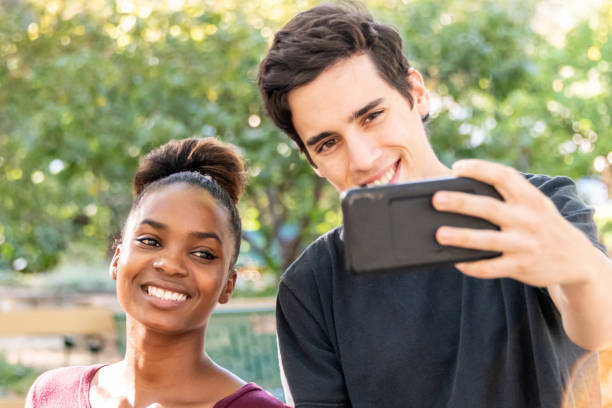 istock Young mixed race couple taking a selfie 1142909599