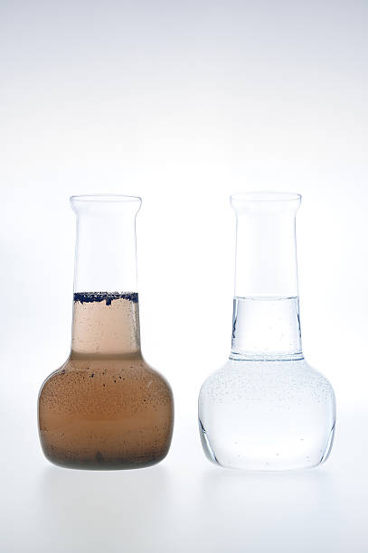 Sample of clean and dirty water in beakers stock photo