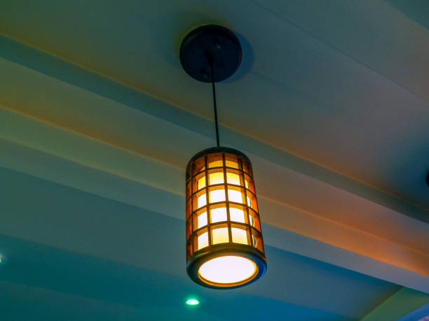 istock Wooden lamp hanging from plaster ceiling 1142921518