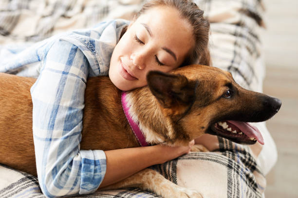 istock Asian Woman Embracing Dog 1142921658