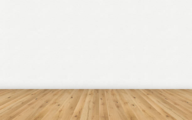 istock Empty room with brown wooden floor and blank white painted wall. Empty loft room for design interior. Long wide picture of empty living space room. 1142922769