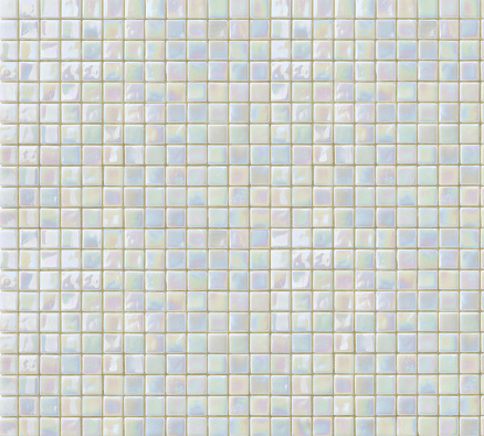 Bright iridescent white and beige mosaic tiles texture background.