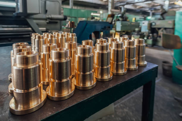 new brass threaded bushings on table in factory - bolt machine part screw threaded imagens e fotografias de stock