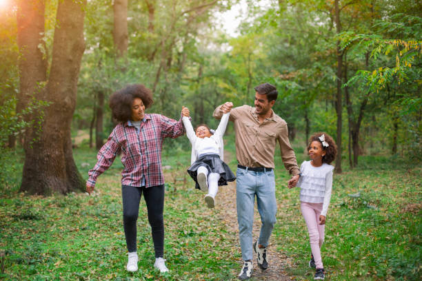 istock Happy family walking along a path in the woods 1142924558