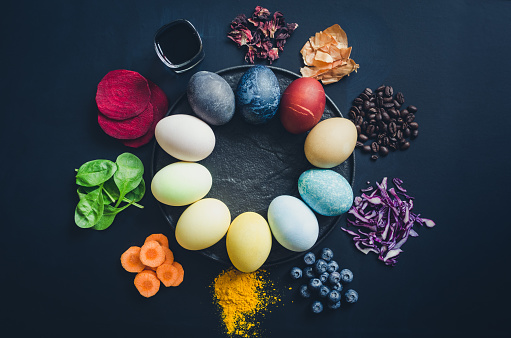 Easter eggs painted with natural egg dye from fruits and vegetables. Homemade naturally dyed Easter eggs with ingredients.