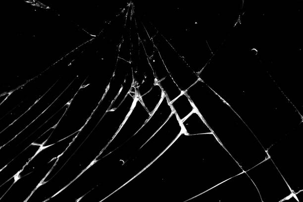 istock cracked glass isolated on a black background. broken glass 1142929579