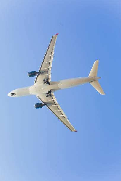 istock Airplane flying under blue sky and white cloud in Phuket, Thailand. 1142929716