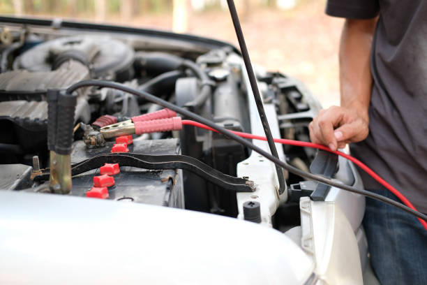 istock mechanic use jumper cables to charge dead car battery 1142929836