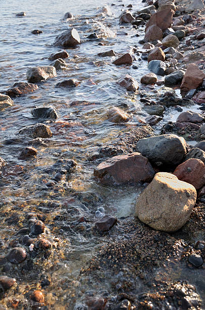 istock Coastal stones and rocks at the evening surf 114293072