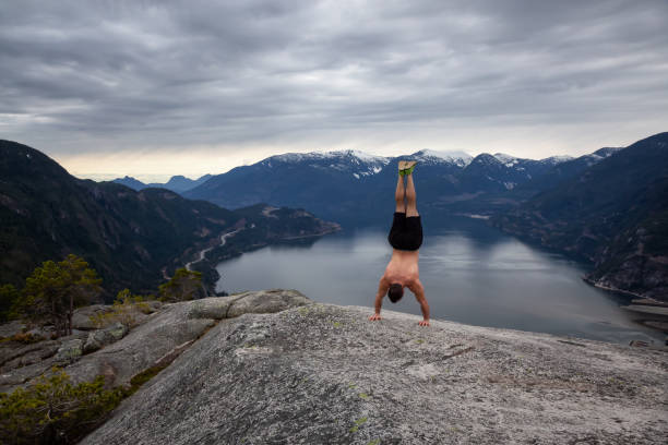 istock Man working out on top of mountain 1142943619