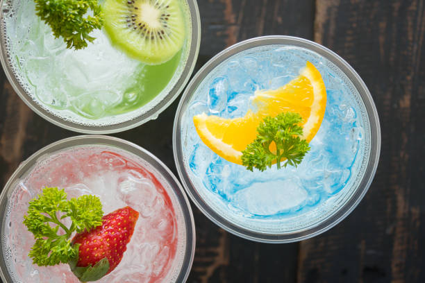 Blue Red Green Italian Soda Cold Beverage and Lemon Strawberry Kiwi Fruit Close Up