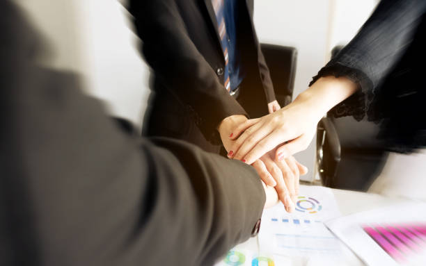 istock Business group team putting hands up for teamwork project success. Combining power and encouragement 1142945223