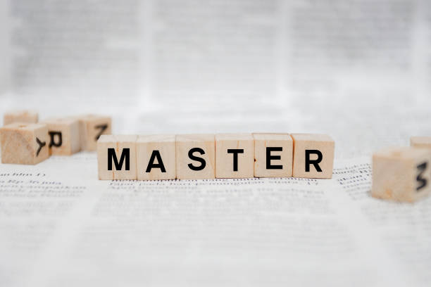 istock Master Word Written In Wooden Cube - Newspaper 1142948858