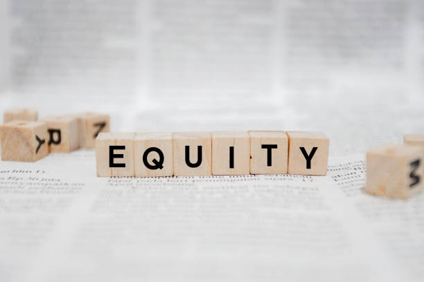istock Equity Word Written In Wooden Cube - Newspaper 1142948903