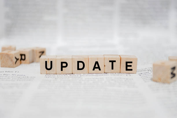 istock Update Word Written In Wooden Cube - Newspaper 1142949835