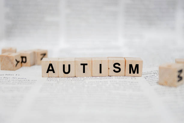 istock Autism Word Written In Wooden Cube - Newspaper 1142950562
