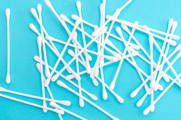 istock White cotton buds scattered on blue background 1142953078