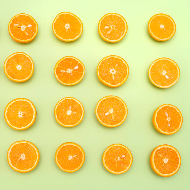 istock Orange juicy oranges split in half on green 1142954197