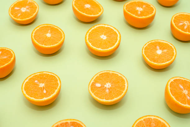 istock Orange juicy oranges split in half on green 1142954210