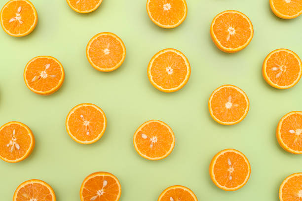 istock Orange juicy oranges split in half on green 1142954220