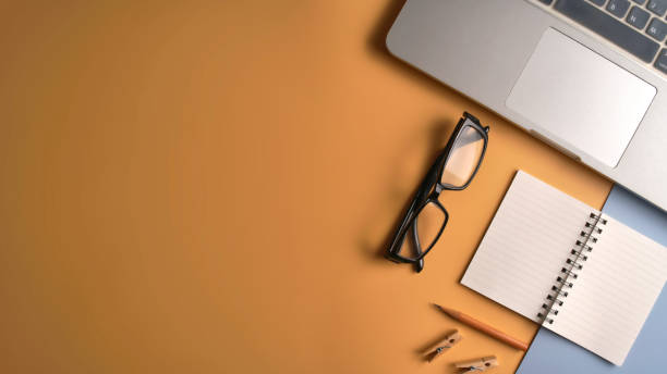 istock Flat lay, top view workspace with eye glasses, notebook, hat, sun block, shoes and coffee cup on yellow background. Summer stylish traveller blogger concept. 1142955628