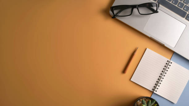 istock Flat lay, top view workspace with eye glasses, notebook, hat, sun block, shoes and coffee cup on yellow background. Summer stylish traveller blogger concept. 1142955639