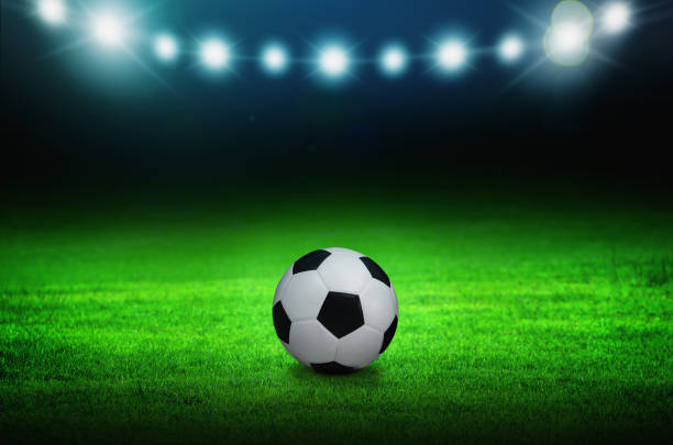 istock Soccer ball on green stadium 1142959914