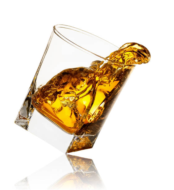 splash of whiskey in glass stock photo