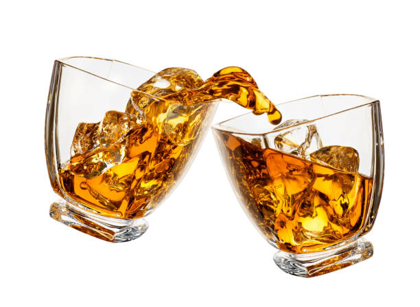 istock glasses of whiskey making toast 1142962398