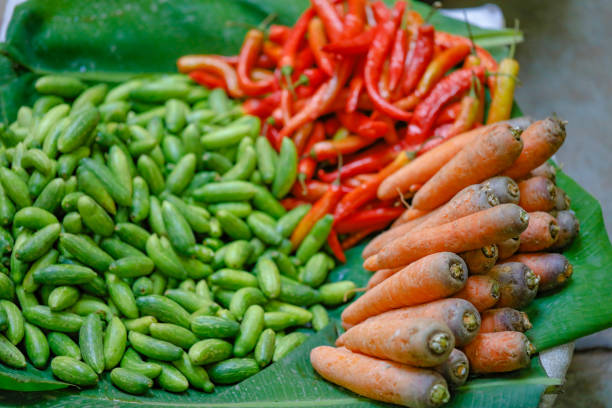 Fruits and vegetables -banana hands, one mango, lettuces, carrot bunches- at a street market next to the building of the Comando 5 de Bomberos -Fire Station 5- in El Vedado neighbourhood. Havana-Cuba.