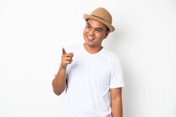istock Young asian man with hat looking on blank space. 1142964609