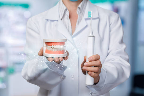 istock A dentist with artificial jaw model and a toothbrush. 1142965237