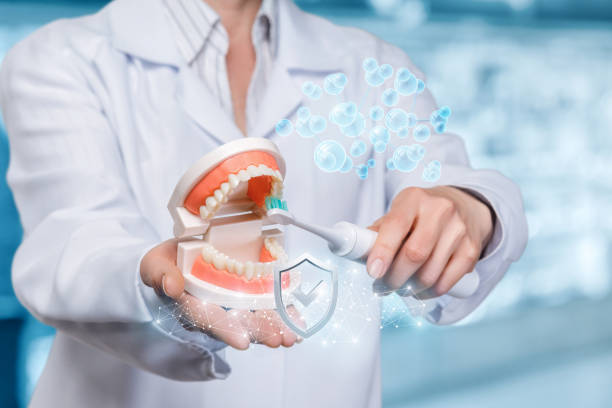 istock A dentist is cleaning teeth of the artificial jaw model. 1142965239