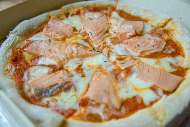 istock Salmon pizza-Italian food style, focus selective 1142965582