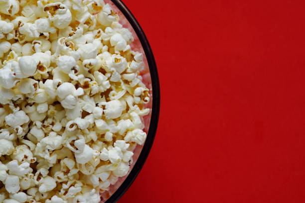 istock Popcorn for watching a movie in a Cup with 3D glasses on a red background 1142965607