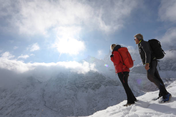 istock View of hikers on snowy mountain trail 1142966435