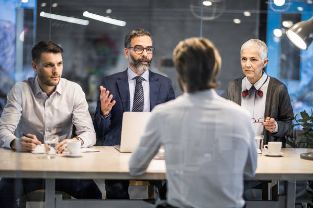 istock Human resource team talking to male candidate in the office. 1142966869