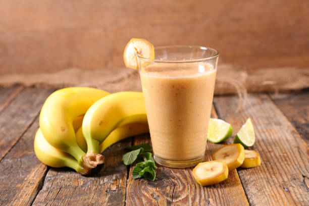 istock banana smoothie on wood background 1142967692