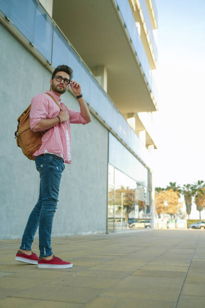 istock Cool young man walking in the street. 1142968278