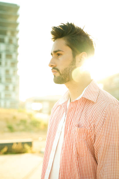istock Stylish young man under city sun 1142968851
