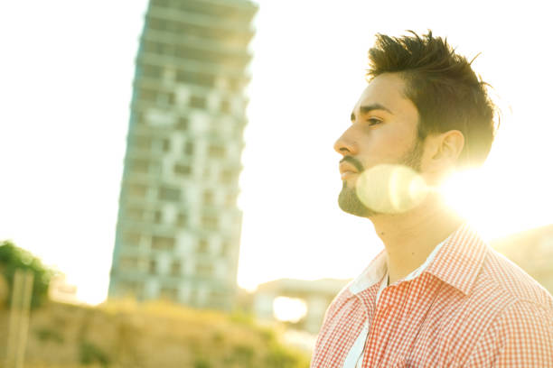istock Stylish young man under city sun 1142969116