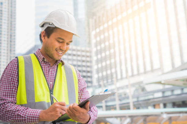 istock Young civil engineer standing near construction building. 1142970529
