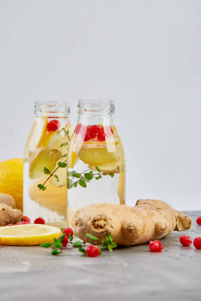 istock Detox water in bottles with cranberrie, ginger, lemon, mint 1142971289