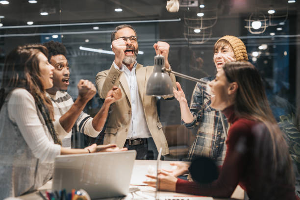 istock Joyful entrepreneurs celebrating their success in the office. 1142971407
