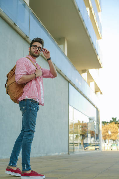 istock Cool young man walking in the street. 1142972995