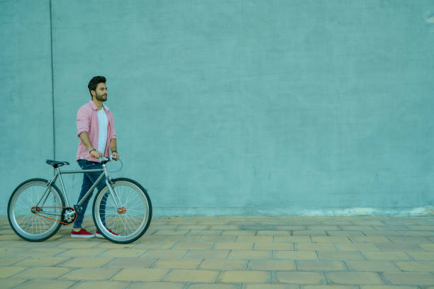 istock Cyclist walking in the street. 1142973229