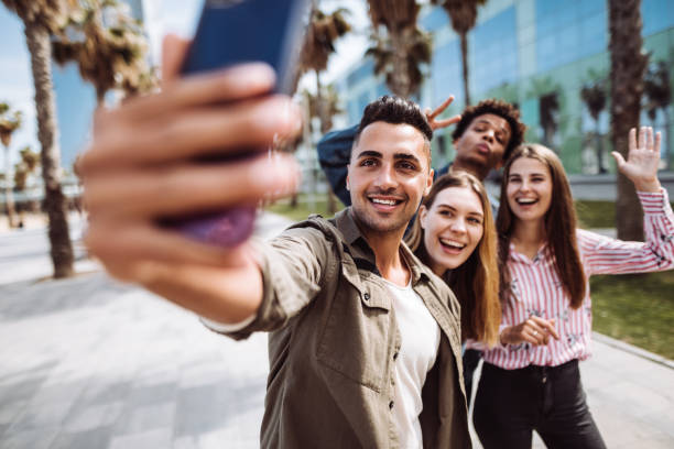 istock friends walking and taking selfie in barcelona 1142973390