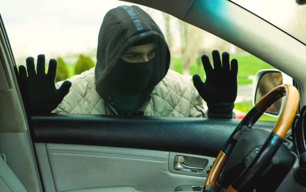 istock Hooded thief looking to break into a car 1142974052