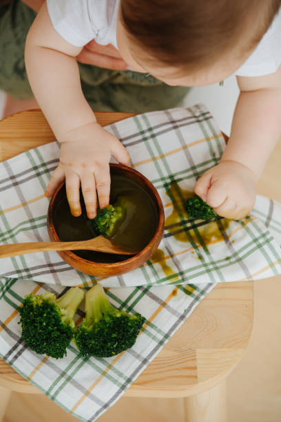 istock Active jolly infant child is given food 1142974090